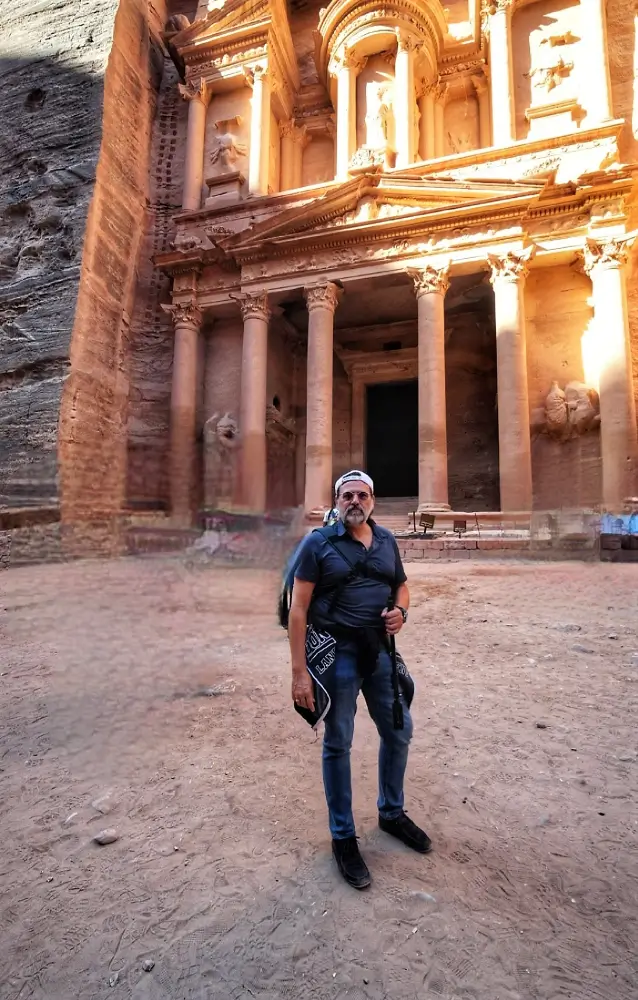 A man standing in front of a building.