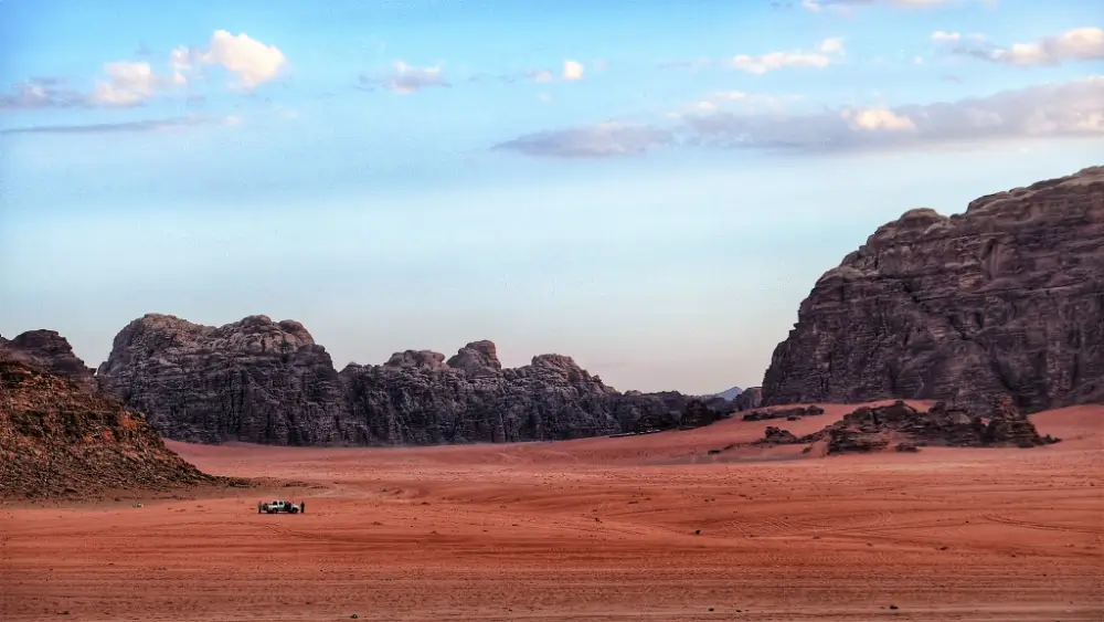 A desert landscape with mountains in the background.