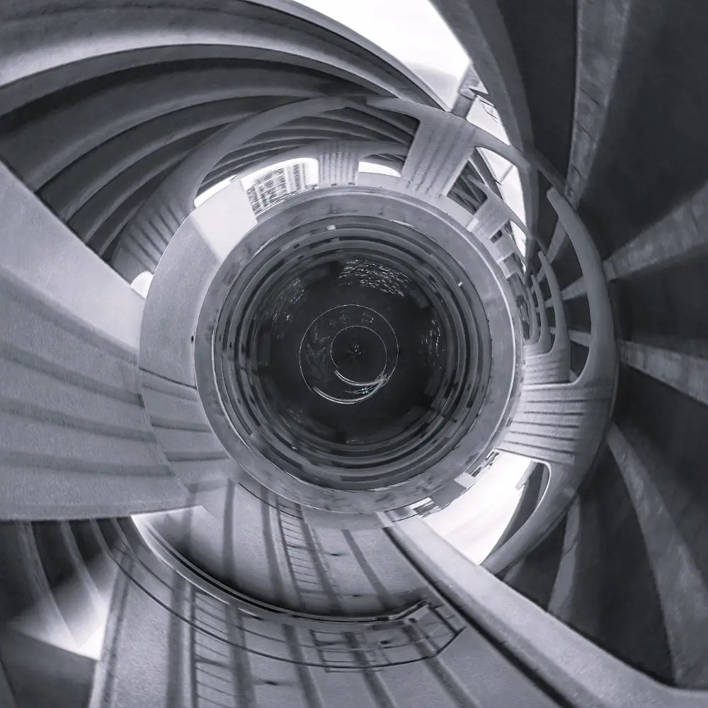 A spiral staircase with stairs going up it.