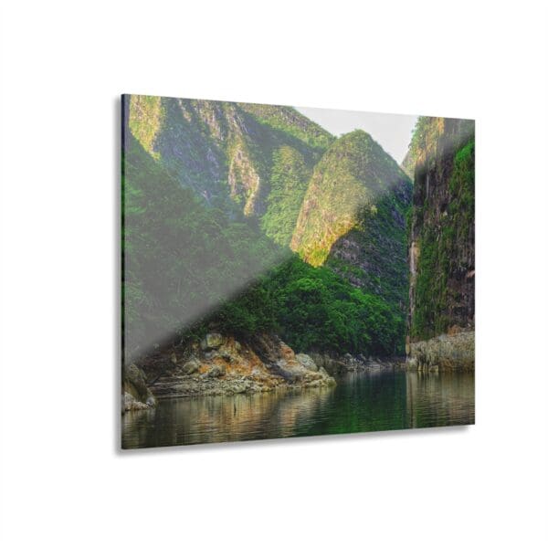 A mountain view with water and rocks in the foreground.