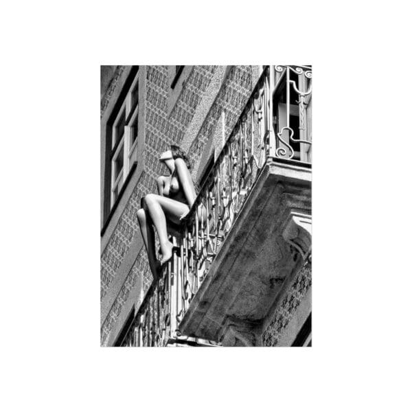 A woman climbing up the side of an old building.