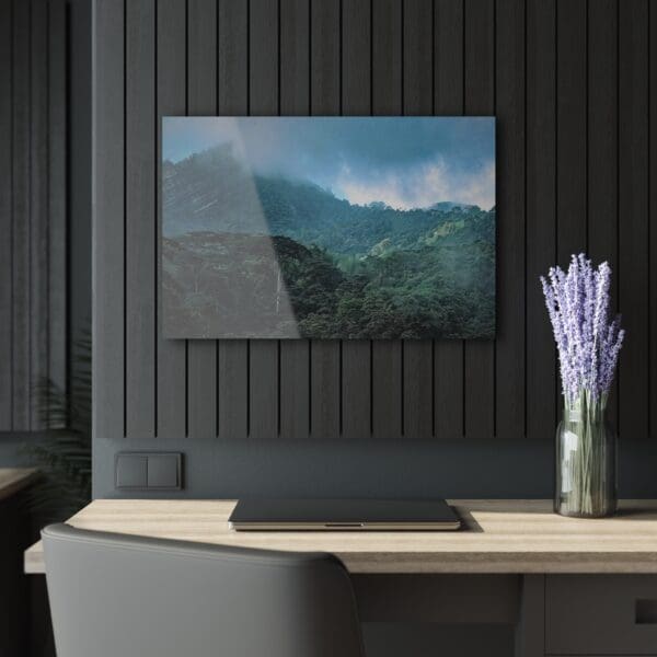 A tv mounted on the wall above a desk.