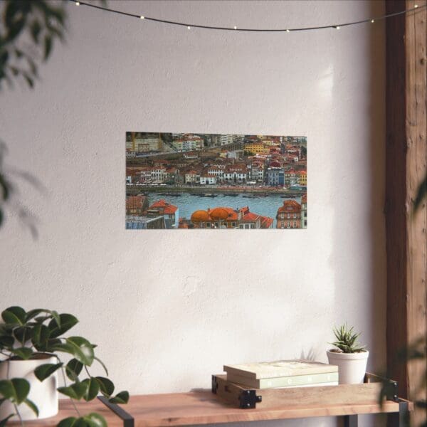 A painting of a city on the wall above a table.