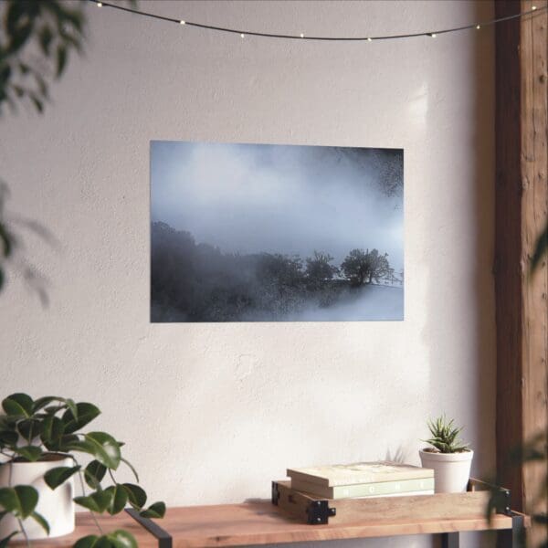 A painting of a foggy mountain range on the wall.