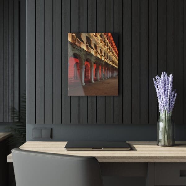 A vase of flowers on the wall next to a table.