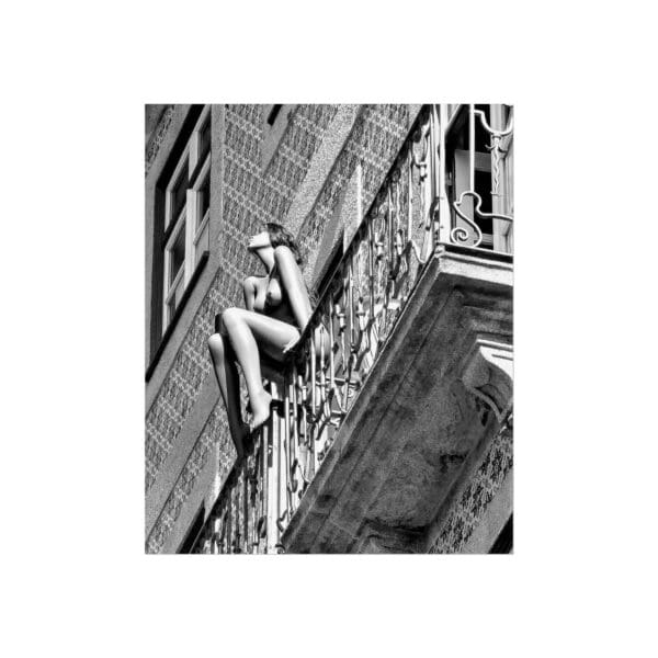 A woman is climbing up the side of a building.