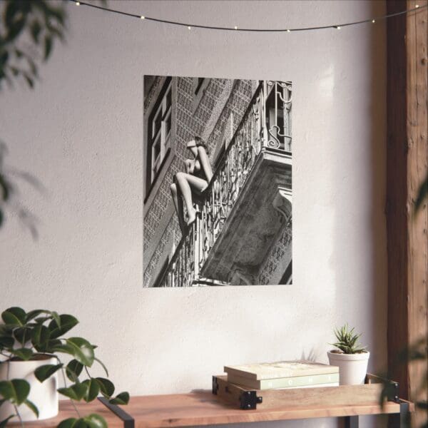 A black and white photo of a person climbing on a wall