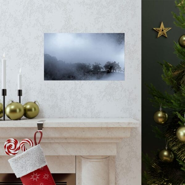 A fireplace with a christmas stocking and a picture hanging on the wall.