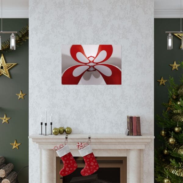 A fireplace with christmas decorations and a painting of a red bow.