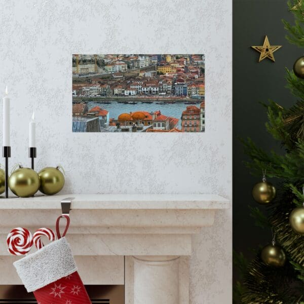 A fireplace with a christmas stocking and a painting of a city.