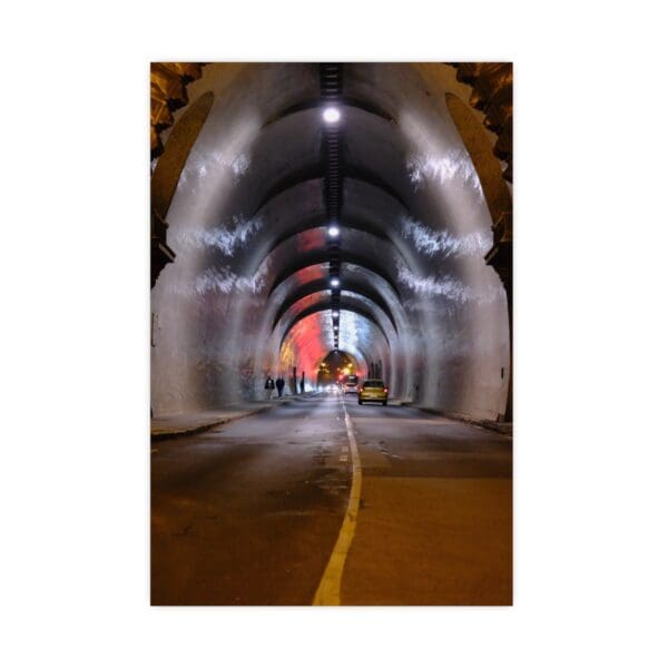 A tunnel with lights and a yellow line