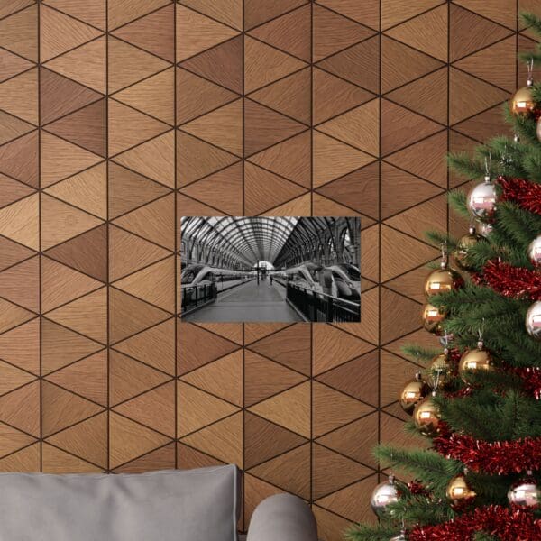 A christmas tree and couch in front of a wall with triangles.