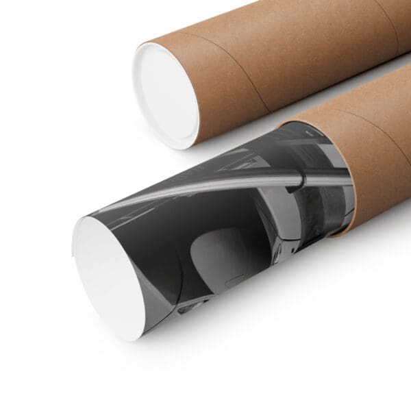 A close up of two cardboard tubes with one tube rolled up