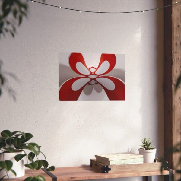 A red and white flower is hanging on the wall