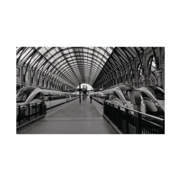 A black and white photo of an empty train station.