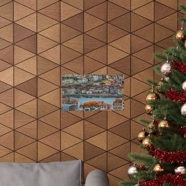 A christmas tree and couch in front of a wall with triangles.