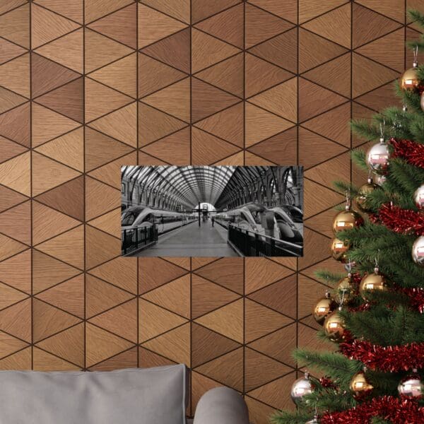 A christmas tree and couch in front of a wall with triangles.