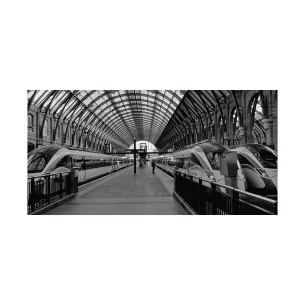 A black and white photo of an empty train station.