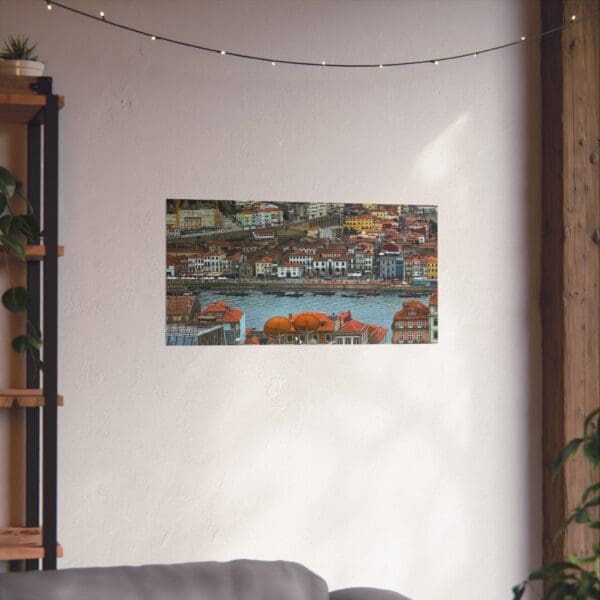 A painting of a city on the wall above a couch.