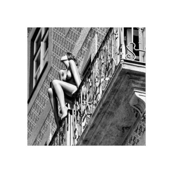 A woman sitting on the side of a building.