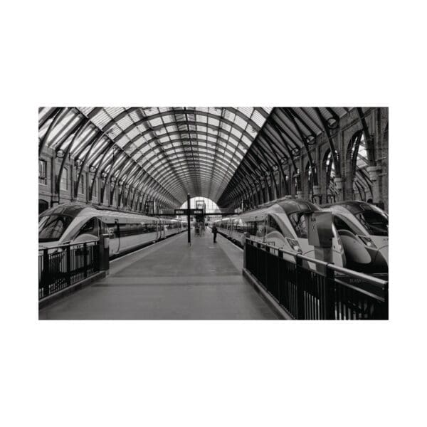 A black and white photo of an empty train station.