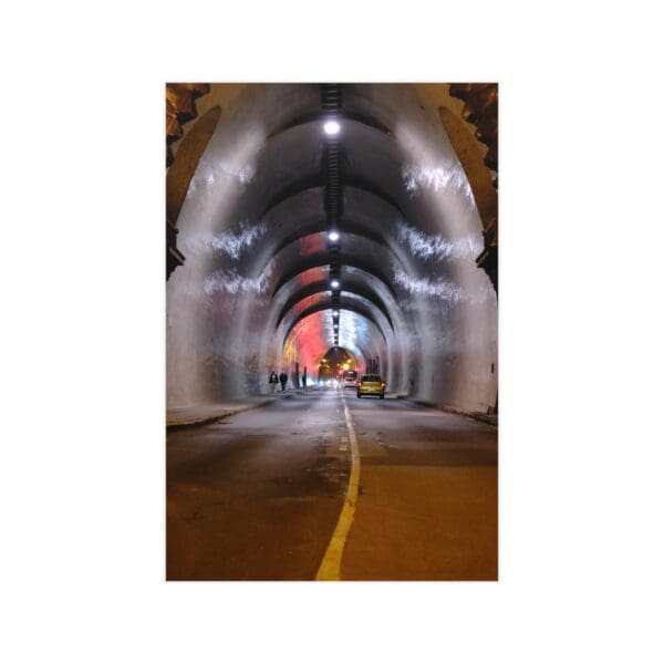 A tunnel with lights and a yellow line