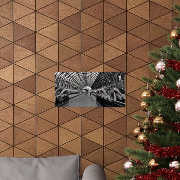 A christmas tree and couch in front of a wall with triangles.