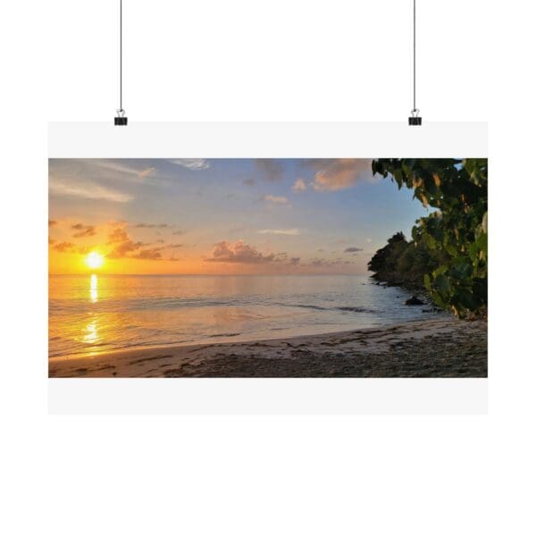 A poster of the sun setting over the ocean.