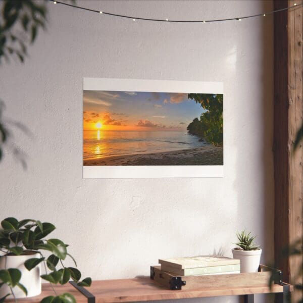 A wall mounted picture frame with the sun setting over the ocean.